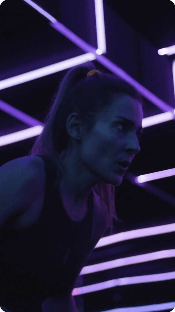 Person exercising in front of neon lights